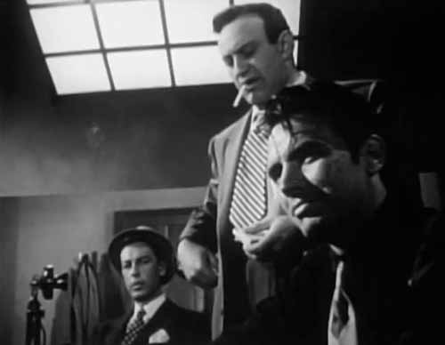 Lee J. Cobb (standing) grills a suspect for the murder he himself committed.