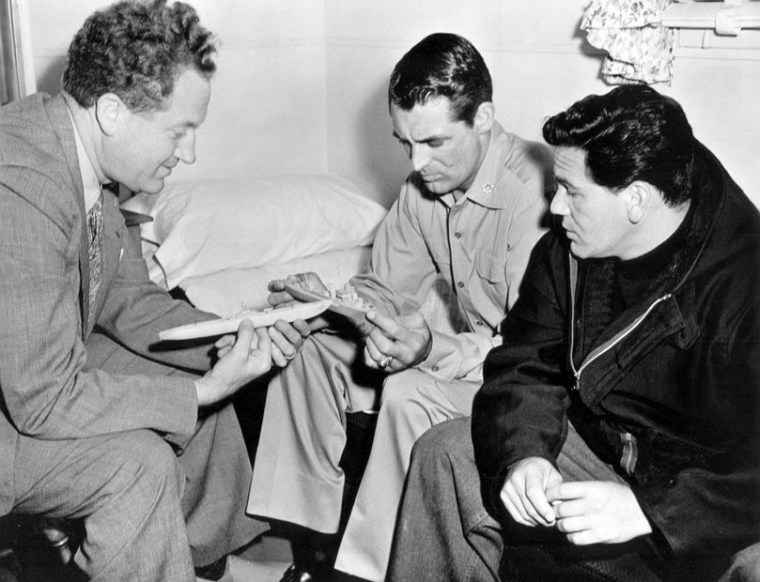 Garfield with director Delmer Daws (L) and Cary Grant on the set. Image: IMDB